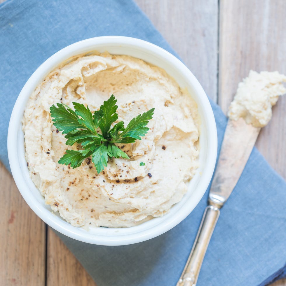 mediterranean diet meal plan hummus in a bowl topped with parsley with knife