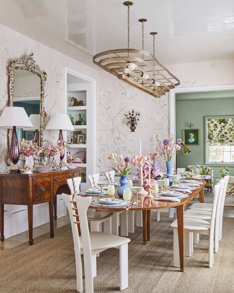 in the dining room, the brass tiered chandelier crowns a custom-made fruitwood table next to the ceh