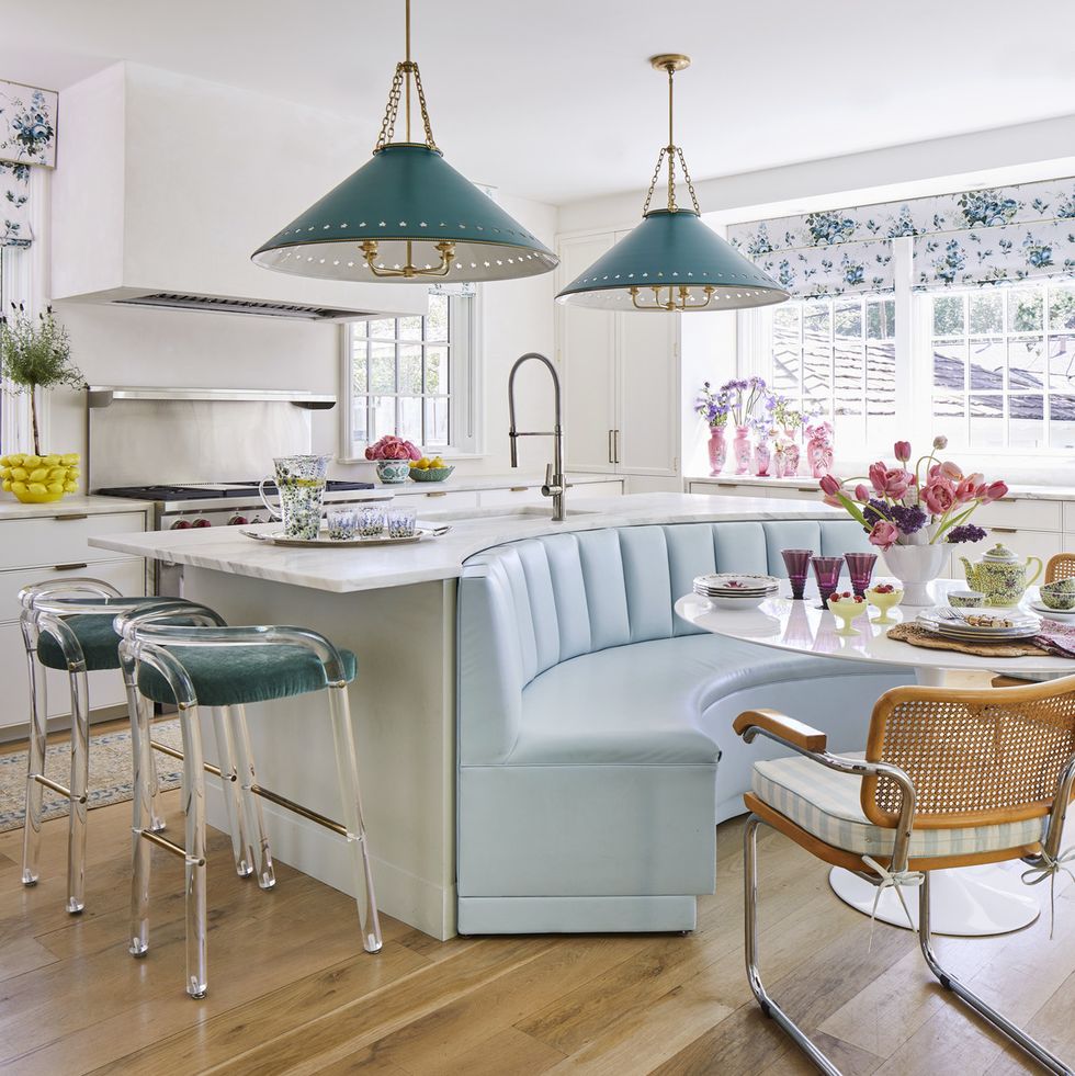 a channel tufted breakfast banquette backs up to a cleverly curved kitchen island