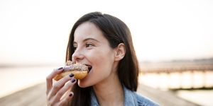 hungry woman eating donut