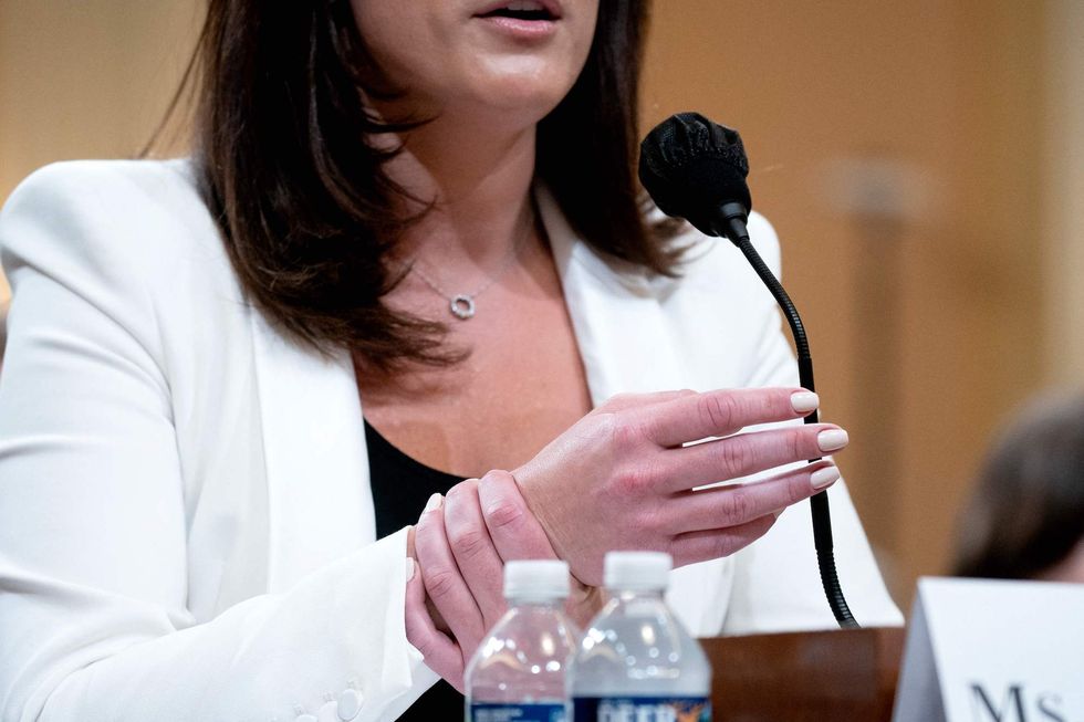 cassidy hutchinson, a top aide to former white house chief of staff mark meadows, holds her wrist while describing the actions of former us president donald trump as he was returning in the limousine to the white house after speaking to supporters on the ellipse, during the sixth hearing by the house select committee to investigate the january 6th attack on the us capitol, in the cannon house office building in washington, dc, on june 28, 2022 photo by stefani reynolds  afp photo by stefani reynoldsafp via getty images