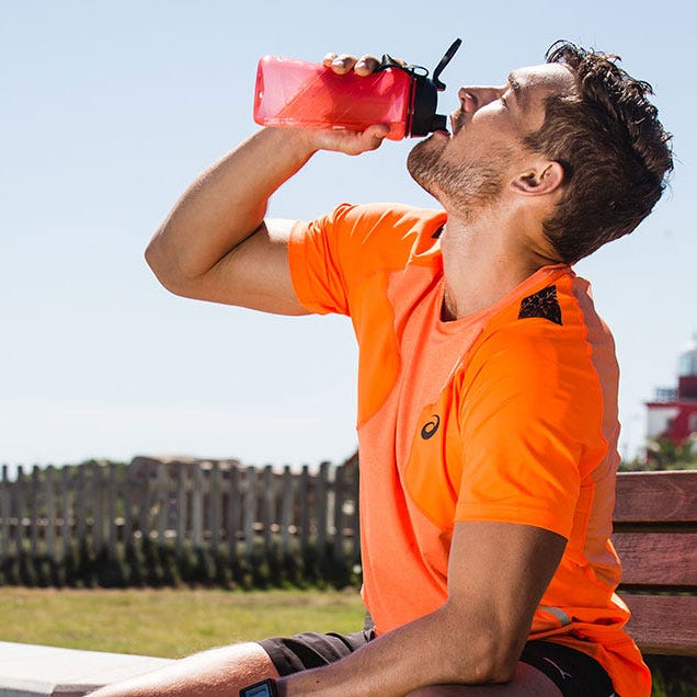 man drinking from sports bottle