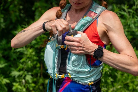 adjusting water bottle on hydration vest