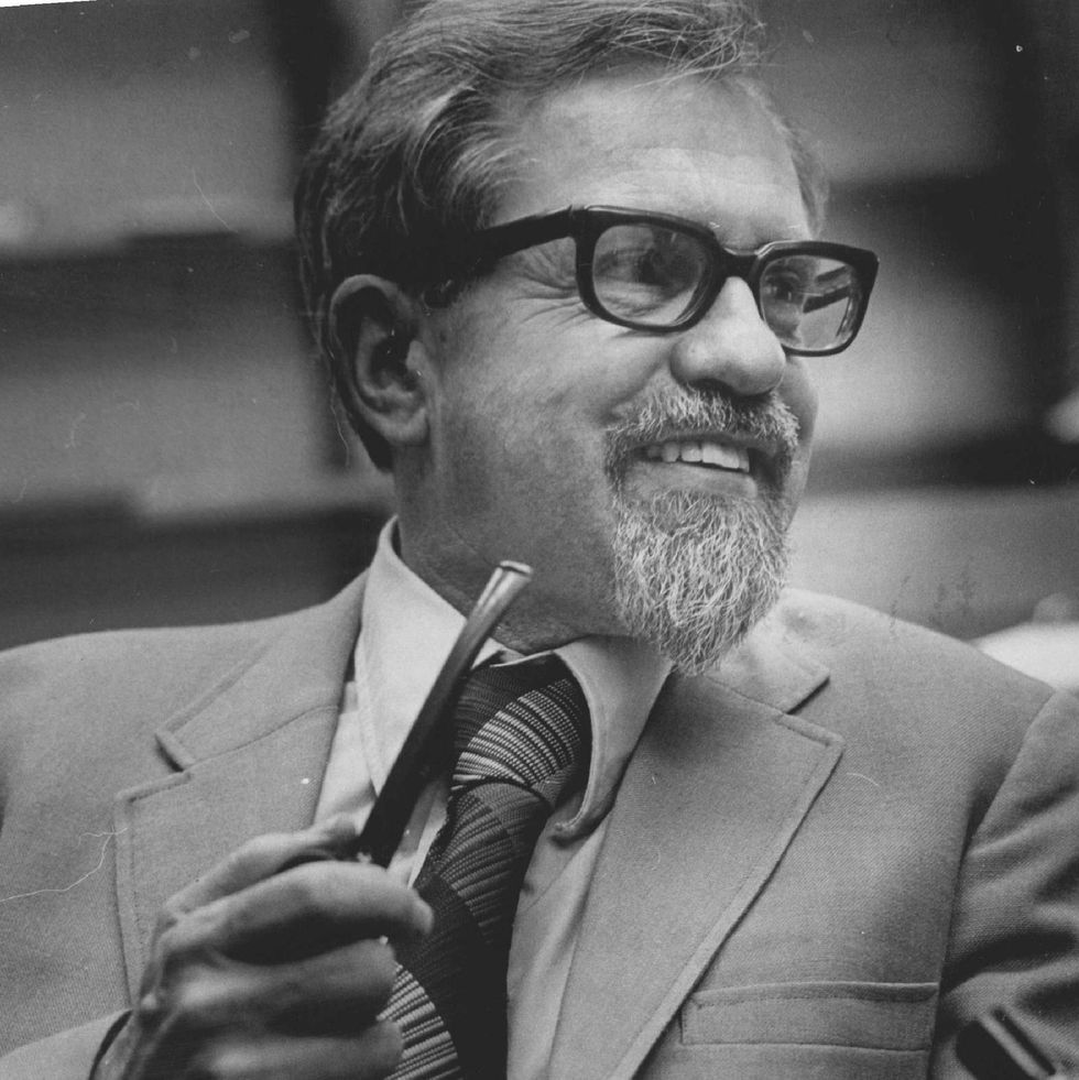 j allen hynek smiling and holding pipe