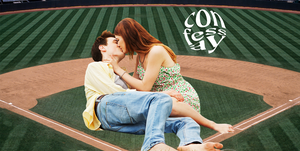 a couple making out on a baseball diamond