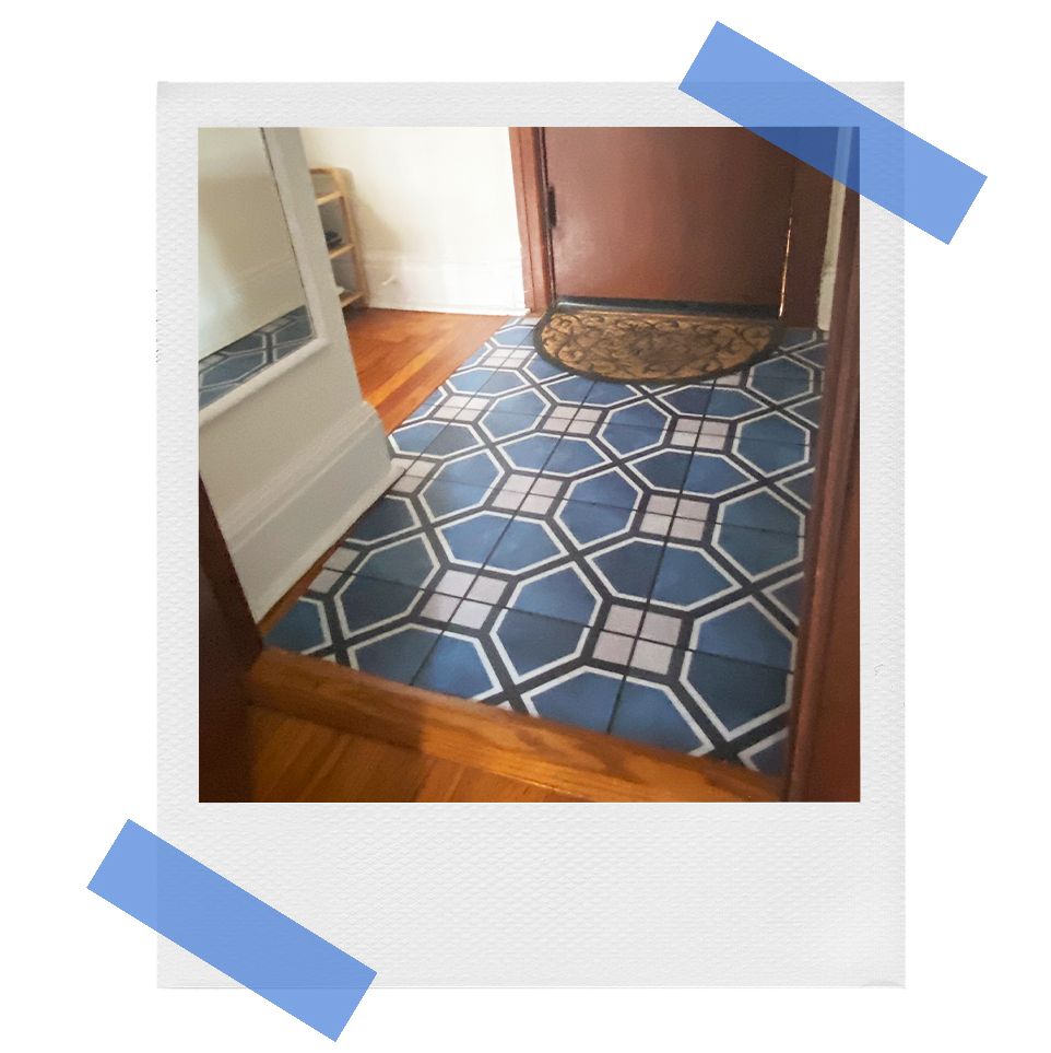 polaroid of chasing paper applied to hardwood floor