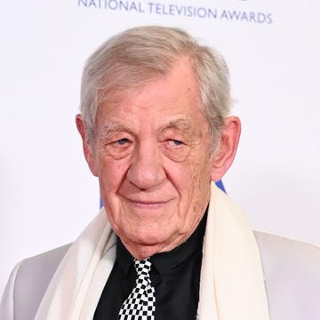 Ian McKellen at the National Television Awards 2023 - Winners Room ian mckellen in the winners room the national television awards 2023 he is wearing a white suit with a black shirt and black and white tie