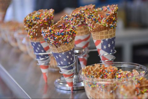 ice cream cones with rainbow sprinkles on the counter