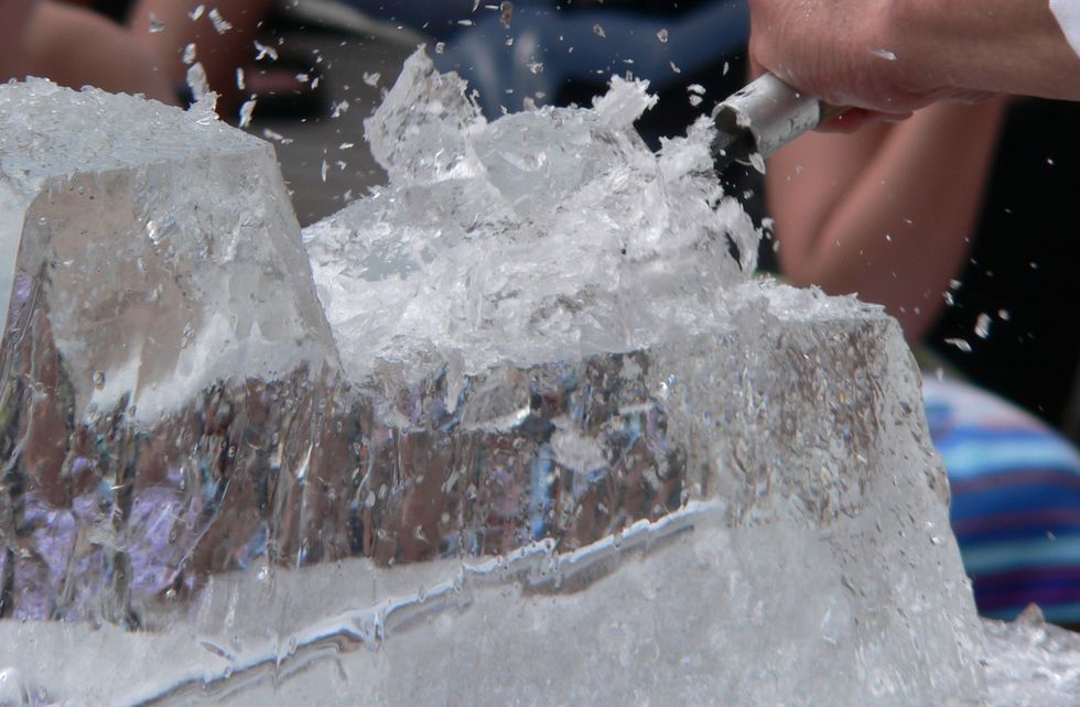 ice sculptor chiseling a creation from a block of ice