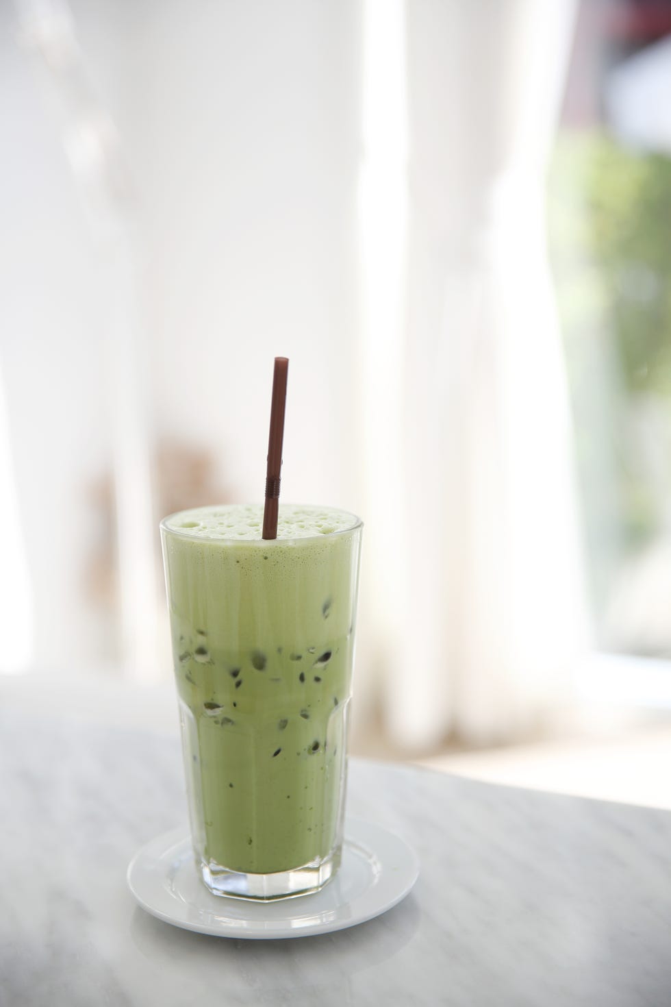 Iced green tea latte in white coffeeshop