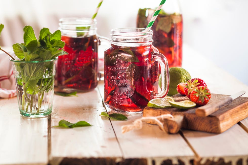 iced tea with fruits, hibiscus, strawberries, mint, limes