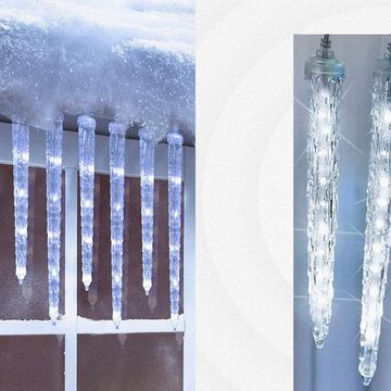 icicle lights hanging on snowy window