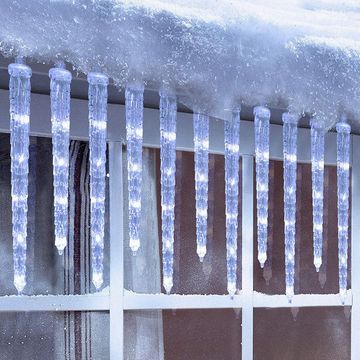 icicle lights hanging on snowy window