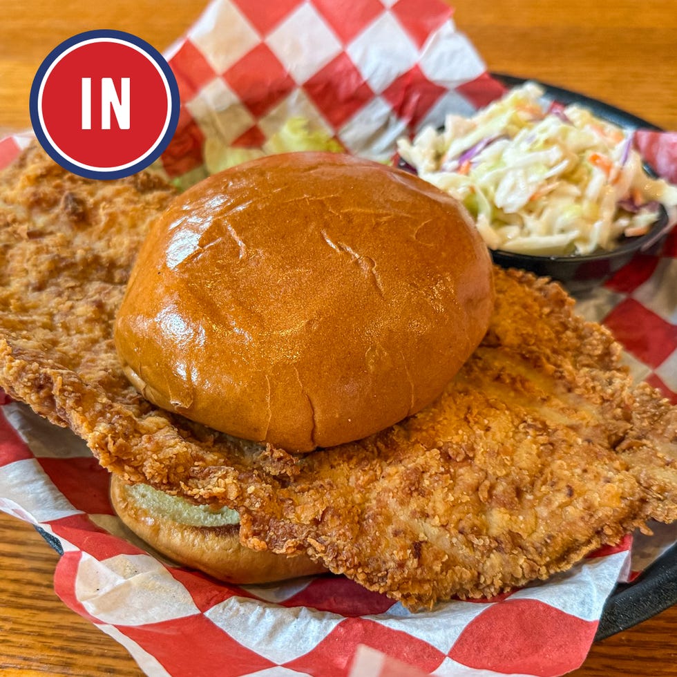 a large chicken sandwich with coleslaw on the side