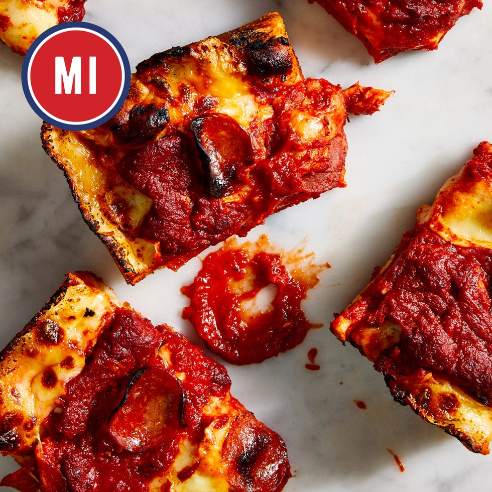 slices of pepperoni pizza with excessive tomato sauce on a marble surface