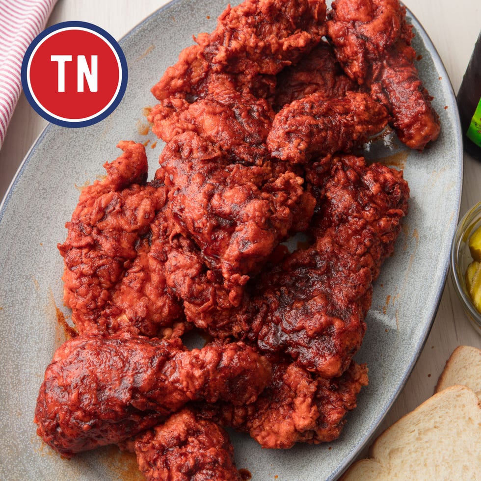 spicy fried chicken on a platter with sides