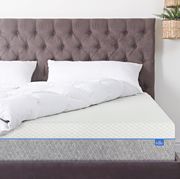 bed with sheets turned up to show mattress