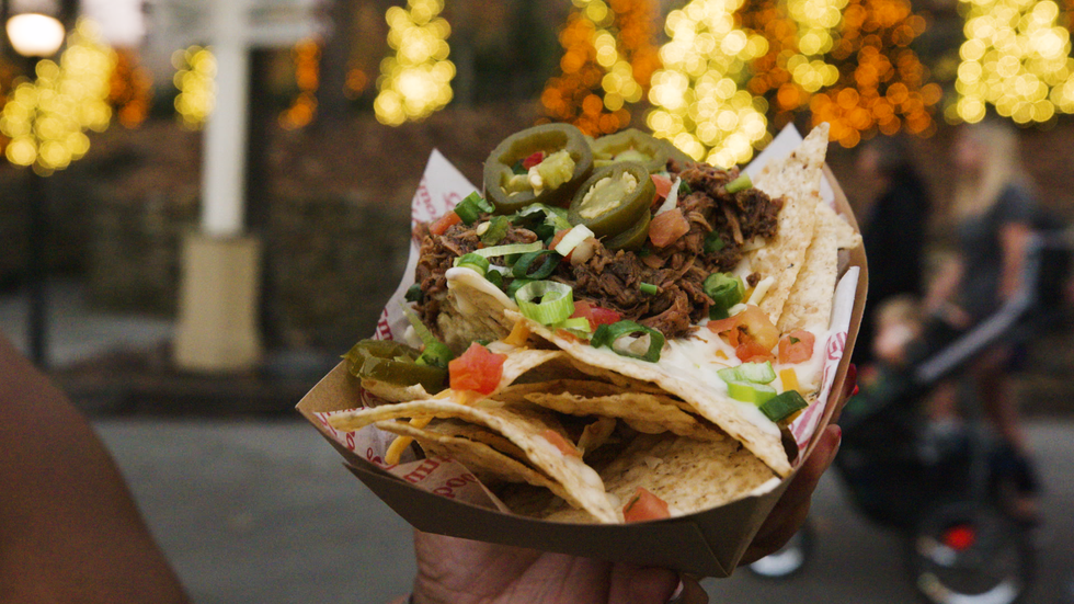 a hand holding a taco