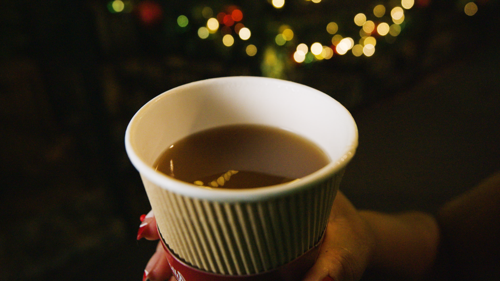 a person holding a cup