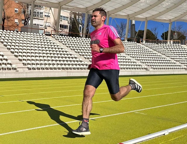a man running on a grass field