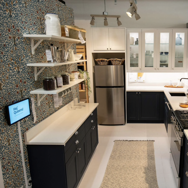 kitchen set in ikea queens, white subway tile, lights, silver fridge black cabinet, white shelves