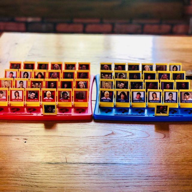 Friends-themed Guess Who game on wooden table