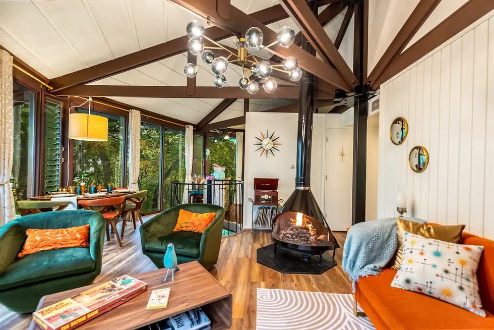 a living room with a chandelier and couches