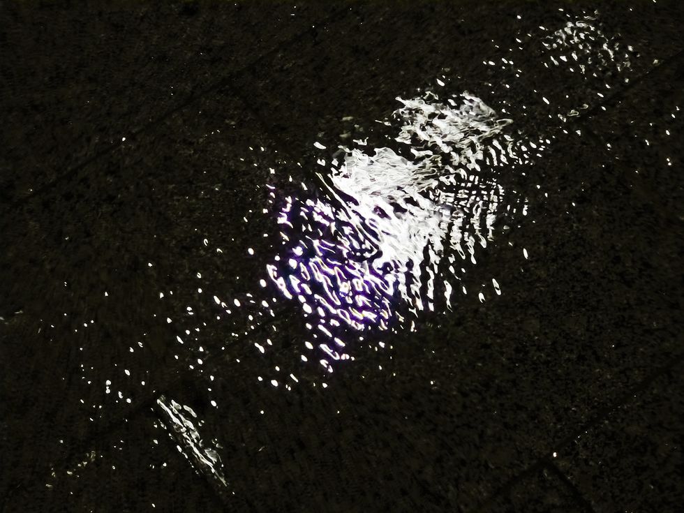 illuminated puddle on the wet asphalt at night
