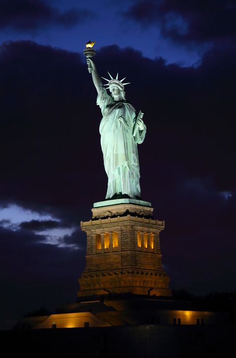 illuminated shot of statue of liberty at dusk