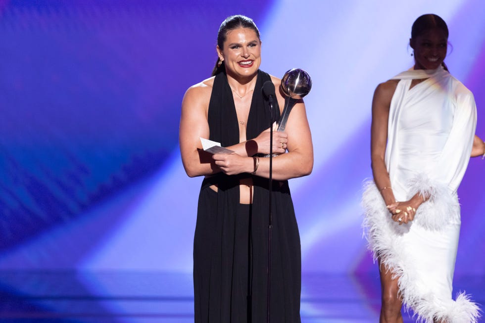 award ceremony with a presenter holding a trophy and a speech note