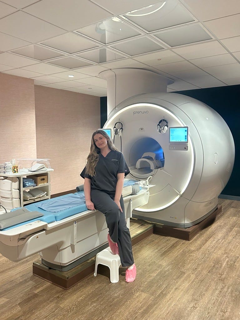 woman standing in diagnostic imaging room featuring a prenuvo mri machine