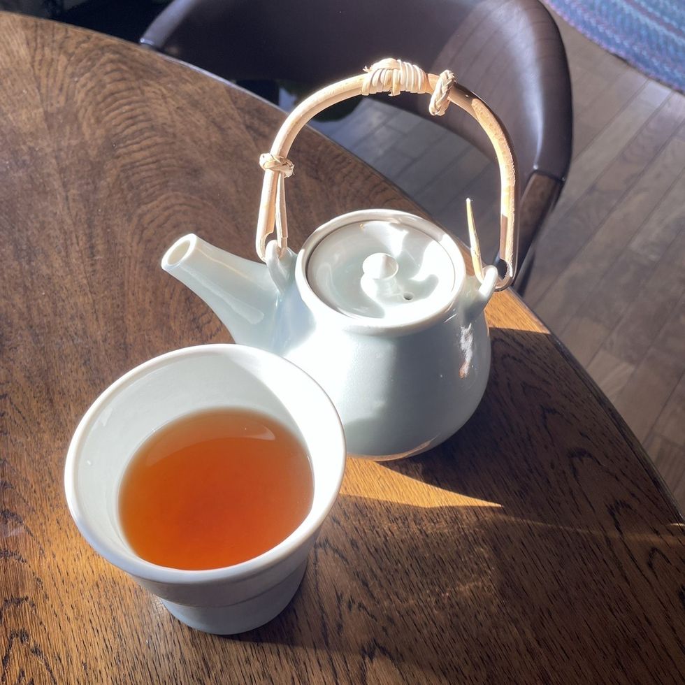 a teapot and a cup of tea on a table