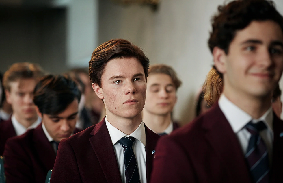 group of students in formal attire participating in a ceremony