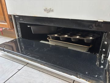 oven broiler drawer filled with pans