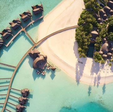 a body of water with buildings and trees around it in iru fushi sun siyam maldives a body of water with buildings and trees around it in iru fushi sun siyam maldives