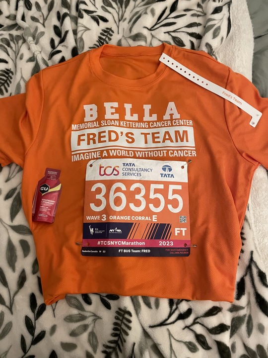 orange shirt race bib energy gel and wristband related to a marathon event