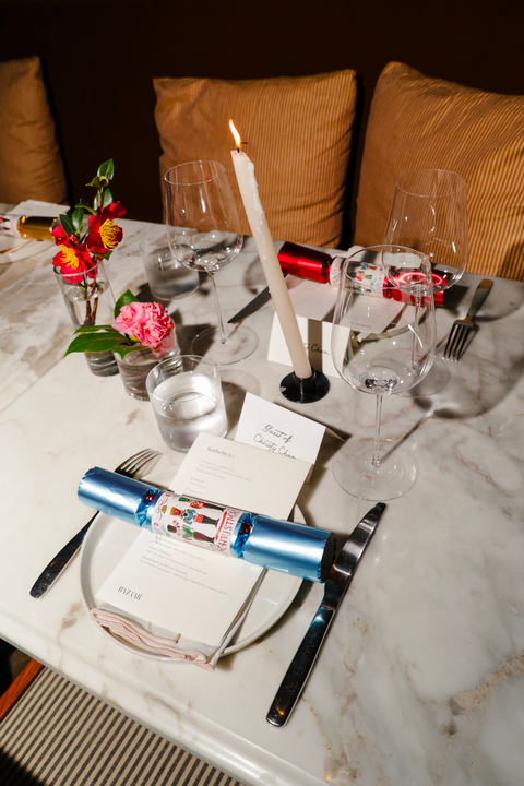 a table with a candle and glasses