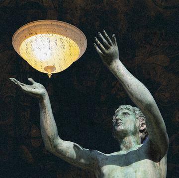 a statue of a person holding a glowing orb