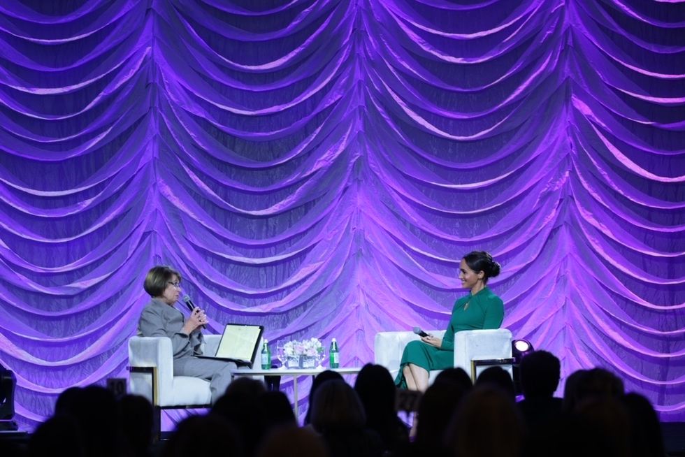 meghan sits onstage during panel