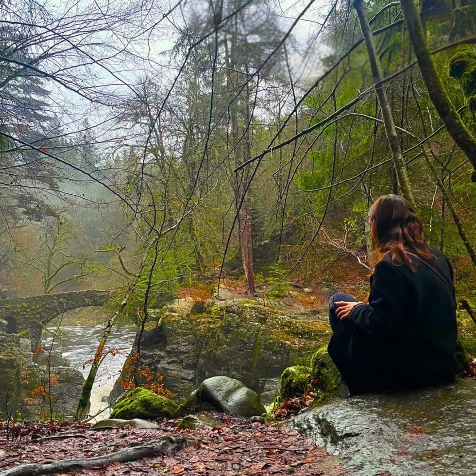 jenna maxwell looking out at hermitage bridge over the river braan