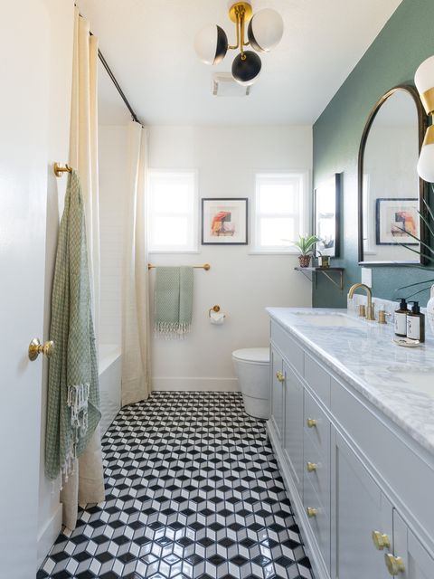 remodeled bathroom with white marble countertops and dark green wall paint