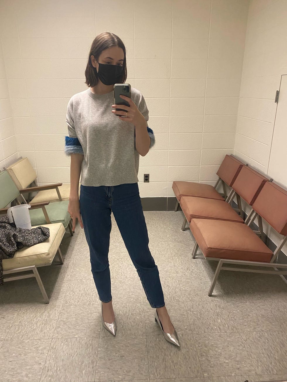 a tester wearing blue everlane jeans with silver heels, good housekeeping's testing for the best denim