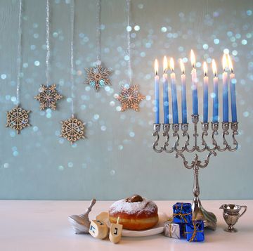 blue hanukkah candles lit on a menorah
