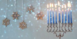blue hanukkah candles lit on a menorah