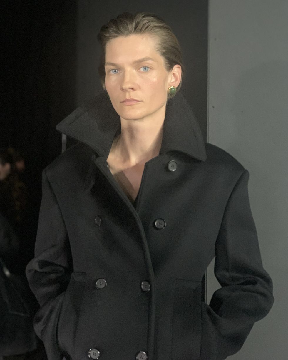 a man wearing a black coat