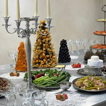 Hands London x Hurs lunch a silver buffet table laid with glasses, vegetable platters and candles