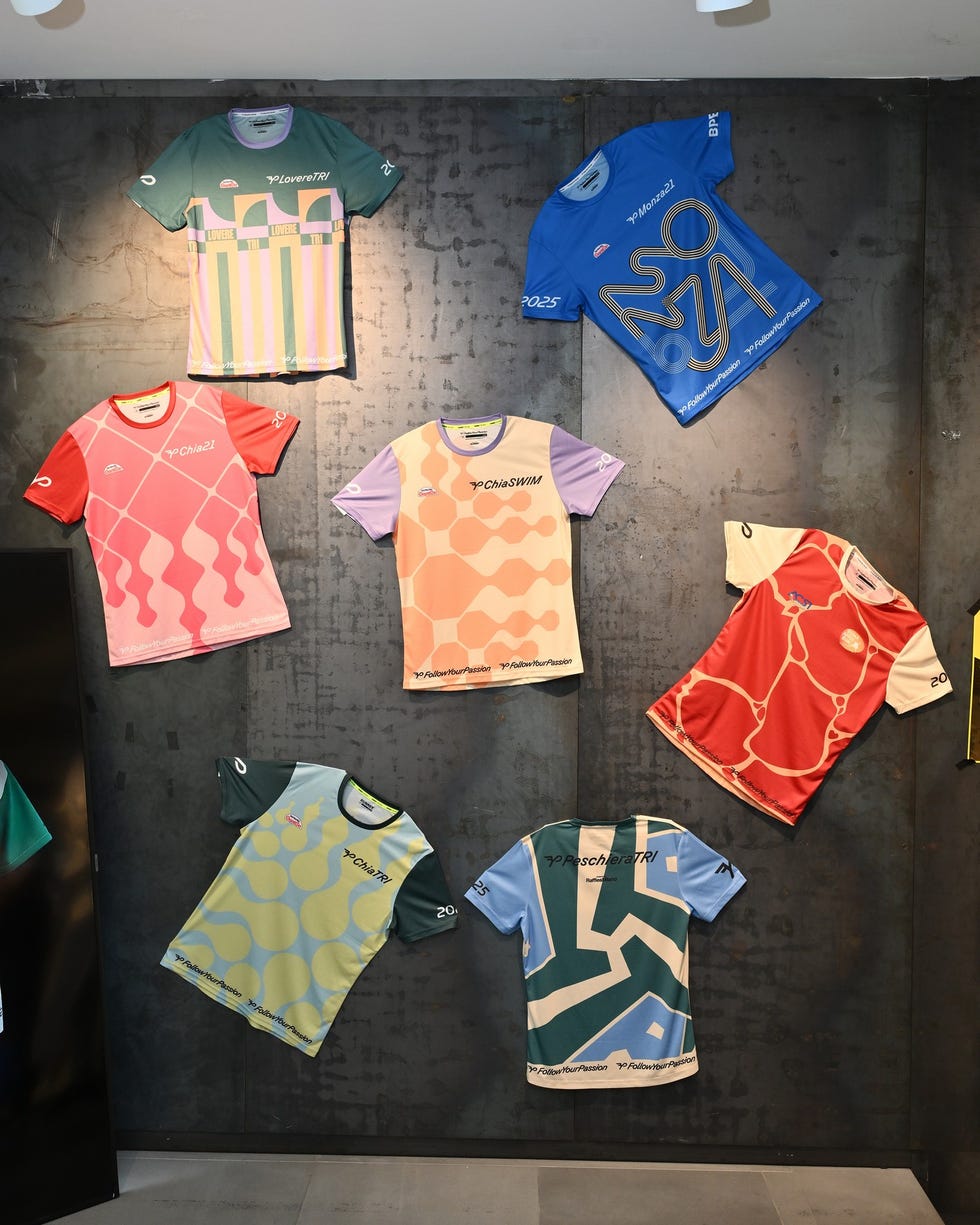 display of various colorful athletic shirts on a wall