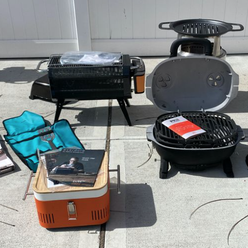 a group of portable grills on a concrete patio surface