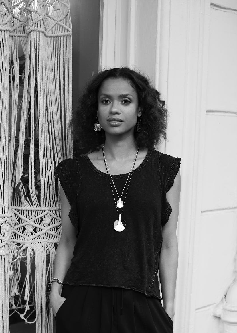 person standing in front of a macrame wall hanging