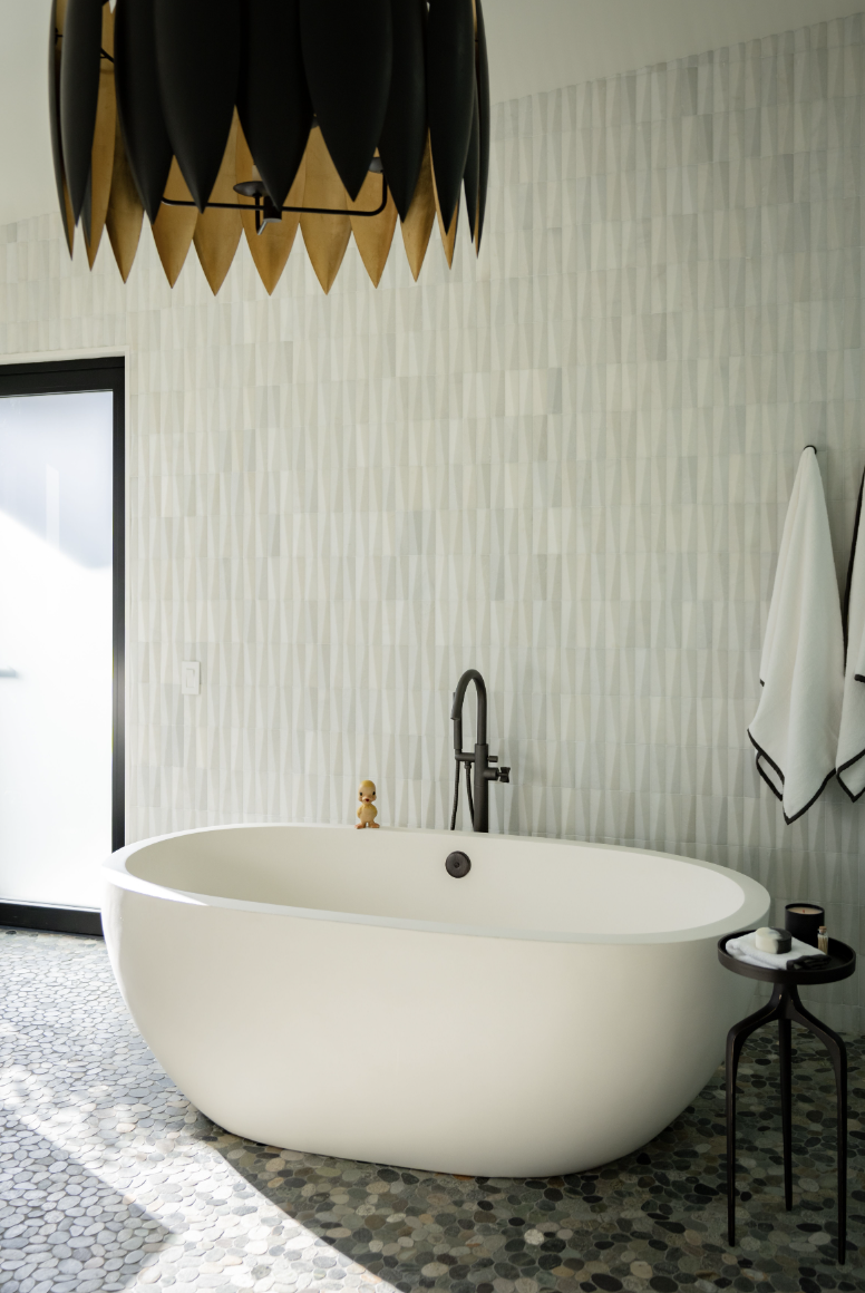 bathroom with soaking tub and geometric textured tiles